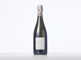 the bottle of champagne is sitting on the table