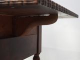 a close up of a wooden table with a glass on top