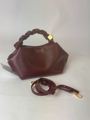 brown leather handbag with handle and strap on white background
