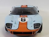 a model of a blue and orange race car on a white surface