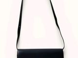 a black bag with a gold buckle on the front