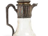 an antique silver and glass coffee pot with a handle