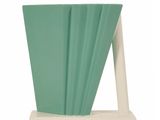 a green vase that is on a stand with a white base