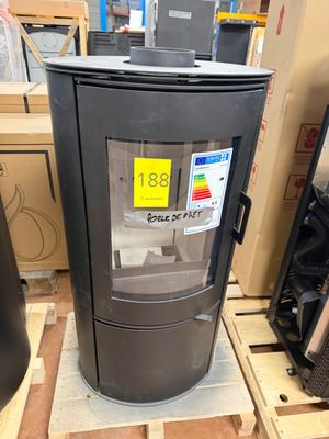 a black stove sitting on a pallet in a warehouse