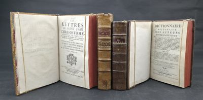 several old books are stacked on top of each other on a table
