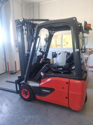 a red fork truck parked inside of a building