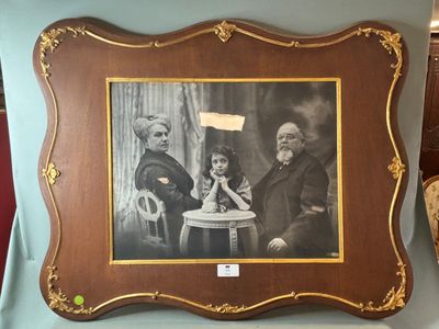 an old picture of a man and a little girl sitting at a table