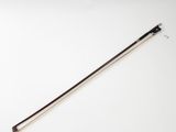 a close up of a violin bow on a white surface