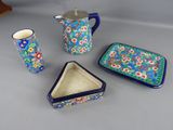 three pieces of pottery are sitting on a table next to each other