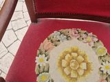 a red chair with a floral design on the back