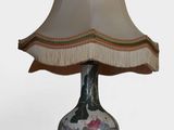 a lamp that is sitting on a table with a lamp shade on it