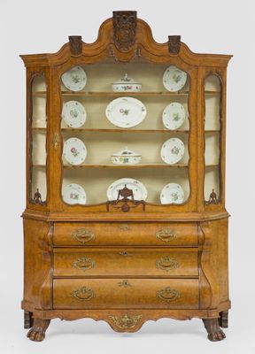 an antique wooden china cabinet with a glass door and ornate carvings