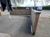 an umbrella that is sitting on the side of a fence