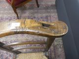 a wooden chair that has a wooden seat on it