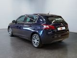 the back end of a blue car parked in a room