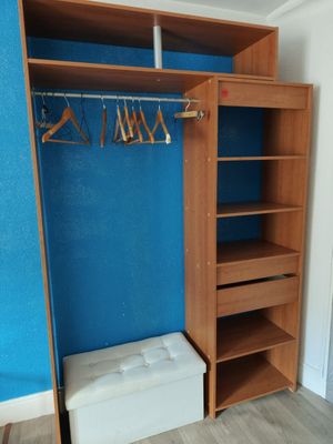 a closet in the corner of a room with blue walls