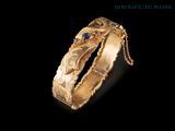 a close up of a gold ring with a blue stone on it