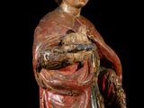 an old statue of a woman holding a baby in her arms