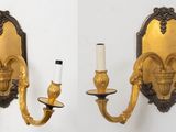 two wall sconces that are attached to the wall
