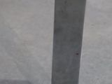 a close up of a metal pole on a concrete floor