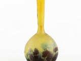 yellow glass vase with black and white floral design on it