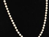 a white pearl necklace on a black mannequin mannequin mannequin mannequin mannequin mannequin mannequin mannequin mann