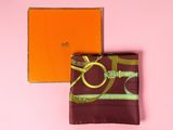 an orange box with a purple scarf and a brown and green scarf