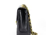 a black chanel bag with a gold chain strap