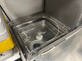 a stainless steel sink in a kitchen with a yellow trash can
