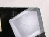 a laptop with a broken screen sitting on a table