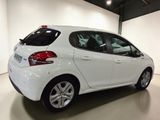 the rear end of a white car parked in a garage