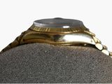 an image of a gold watch on a mannequin