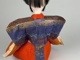 an image of a doll with a black hair and a blue and orange kimono