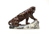statue of a tiger on a rock on a white background