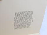 an open book with writing on it sitting on a table