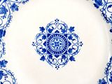 a blue and white plate with a floral design on it