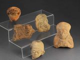 several pieces of pottery are displayed on a clear display case