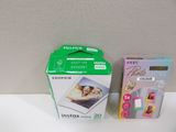 a box of instant photo prints next to a box of instant photo prints