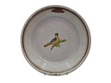 a plate with a bird painted on the side of it