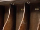 a wooden shelf with a bunch of hooks on it
