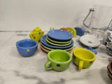 a lot of dishes and cups sitting on the counter
