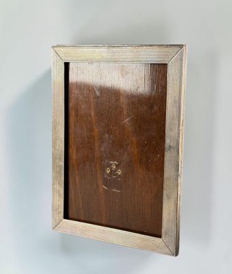 an old wooden picture frame hanging on a white wall