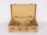 an old suitcase that is open on a white surface