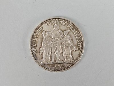 a close up of a coin on a white surface