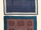 two pieces of blue and brown patterned fabric on a white background