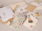 a pile of mail sitting on a table next to a pair of scissors