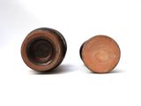 two brown vases sitting next to each other on a white surface