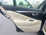 the interior of a car with the door open and the driver ' s seat down