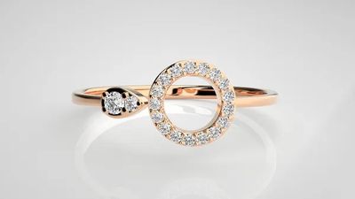 a close up of a diamond ring on a white surface