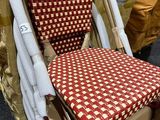 a chair with a red and white checkered seat pad on it